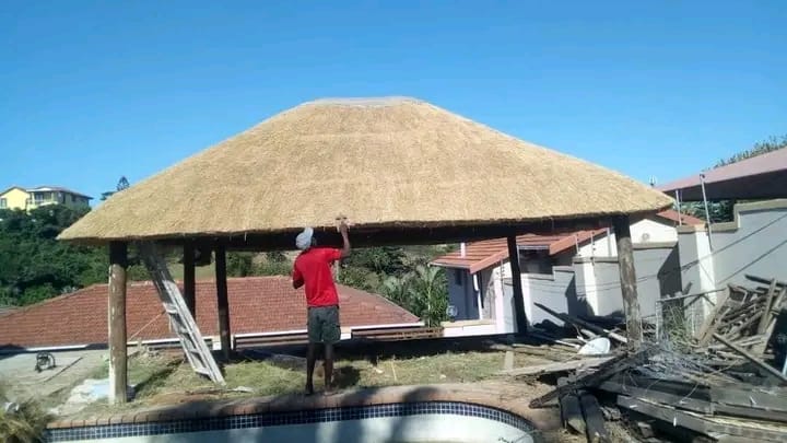 Lovemore team working on thatch roof